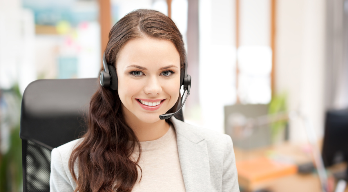 A woman wearing a headset and smiling