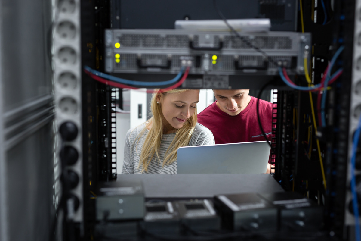 Two people working on servers