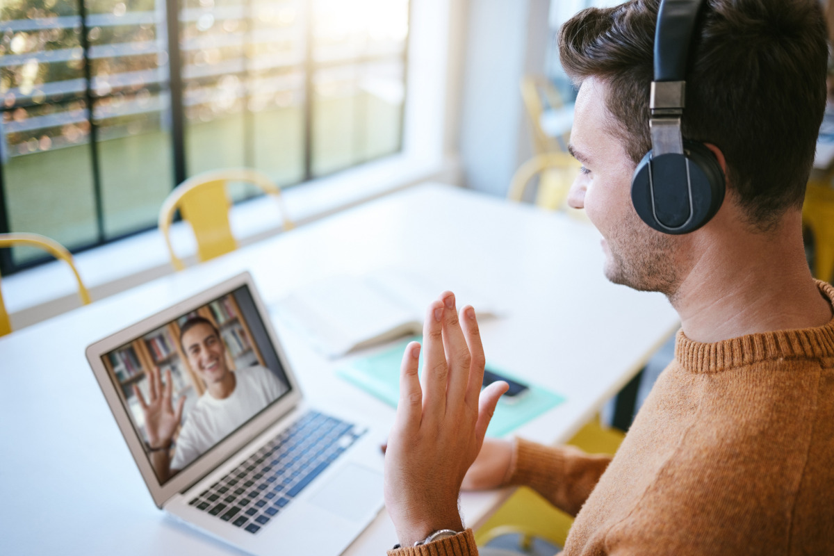 Two men video conferencing on laptops