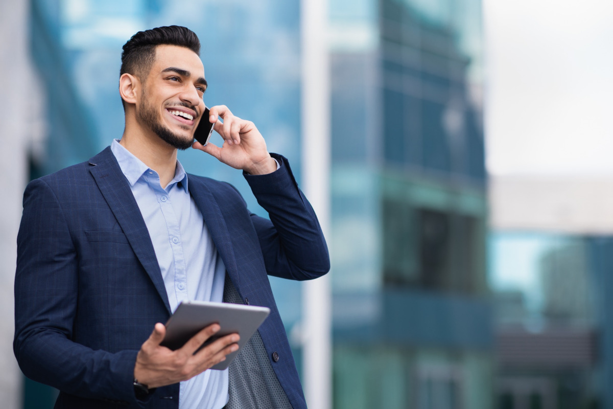 Handsome man speaking on phone and smiling